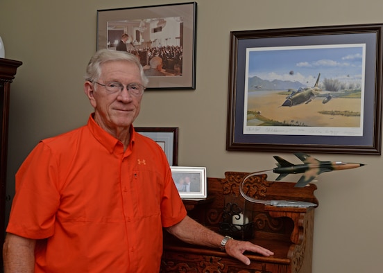 Retired Lt. Col. Richard “Gene” Smith stands next to a model F-105 Thunderchief aircraft June 29, 2015, at his home in West Point, Mississippi. He spent over five years as a prisoner of war in Vietnam after ejecting from his aircraft in 1967. 