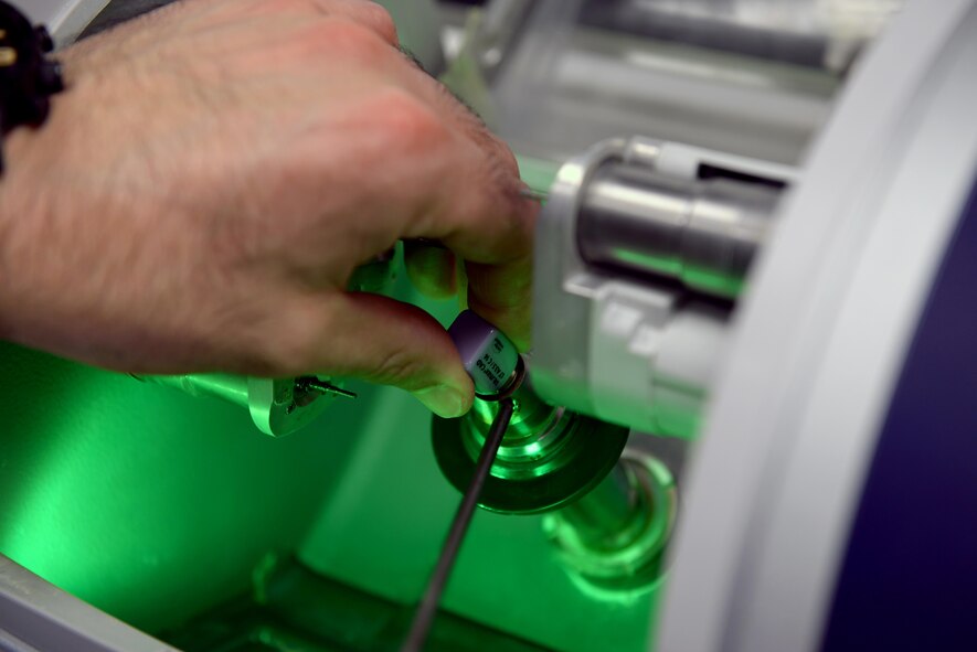 Capt. Jacob Deniakos, 42nd Medical Group general dentist, places a porcelain block into a milling machine at the Maxwell Dental Clinic, Mar, 14, 2017. The porcelain used to make one-day crowns is between six to eight times stronger than the porcelain that was used to make traditional crowns prior to the newest technology the dental clinic is now using. (U.S. Air Force photo/Senior Airman Tammie Ramsouer)