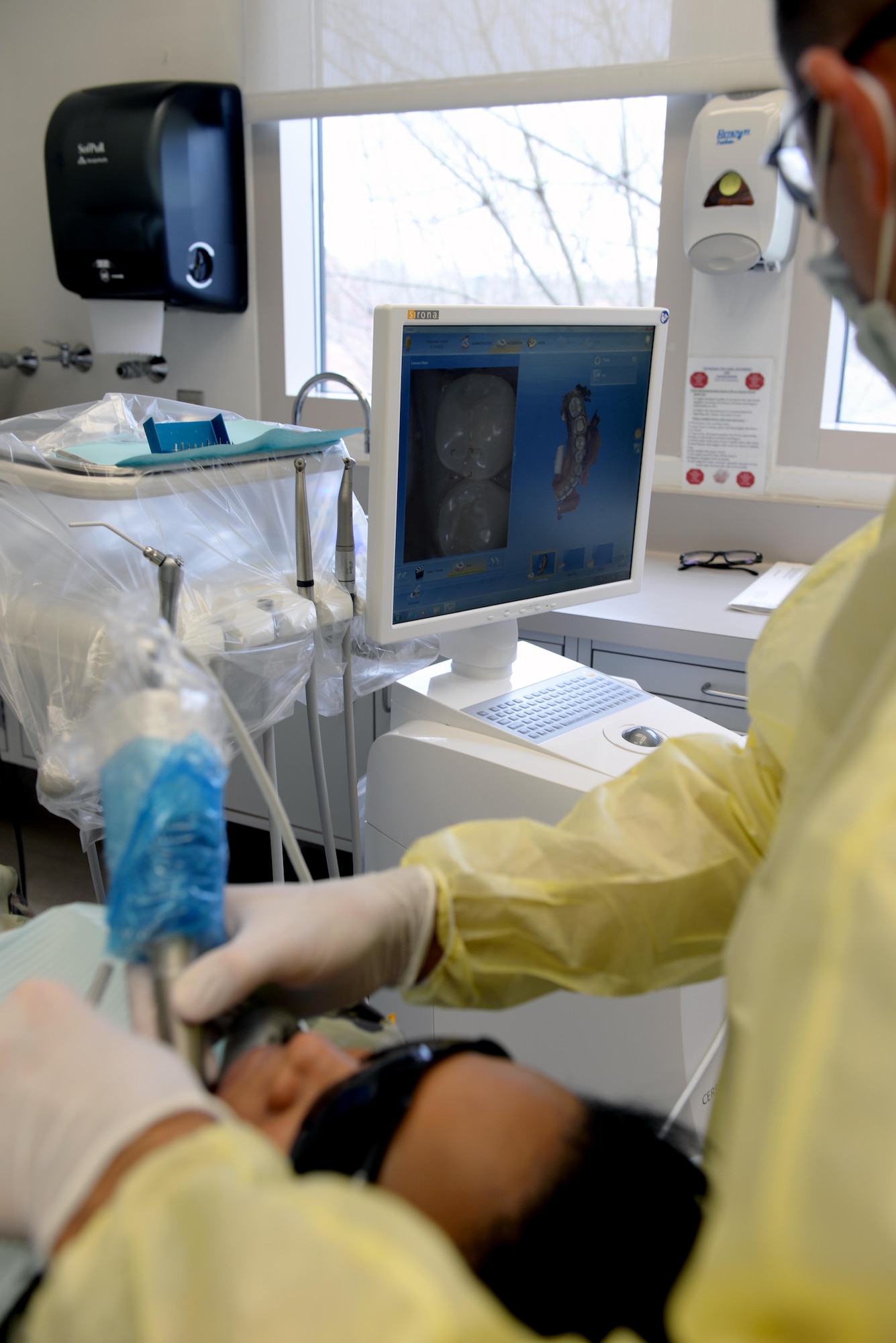 Capt. Jacob Deniakos, 42nd Medical Group general dentist, uses the Computer Assisted Design and Computer Assisted Milling program to map a patients’ jaw-line to digitally create a crown at the Maxwell Dental Clinic, Mar. 14, 2017. The program takes hundreds of pictures and combines them all into one 3-D map of the patients’ teeth to analyze the best size and shape of crown for the patient. (U.S. Air Force Photo/Senior Airman Tammie Ramsouer)