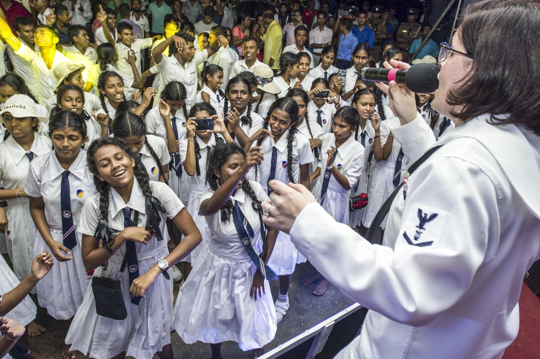 Students in Matara, Sri Lanka dance and sing along as Navy Petty Officer 3rd Class Emileigh Kershaw performs during Pacific Partnership 2017, March 14, 2017. Navy photo by Petty Officer 2nd Class Chelsea Troy Milburn