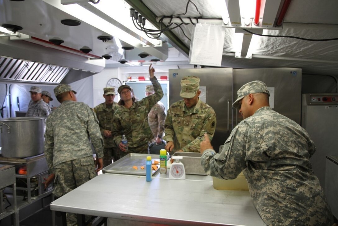 United States Army Reserve Command Chief W5 Pamela Null checks the cooling vents in the containerized kitchen during the 49th MMB Food Service Team during the 2017 Connelly in Puerto Nuevo, Puerto Rico.