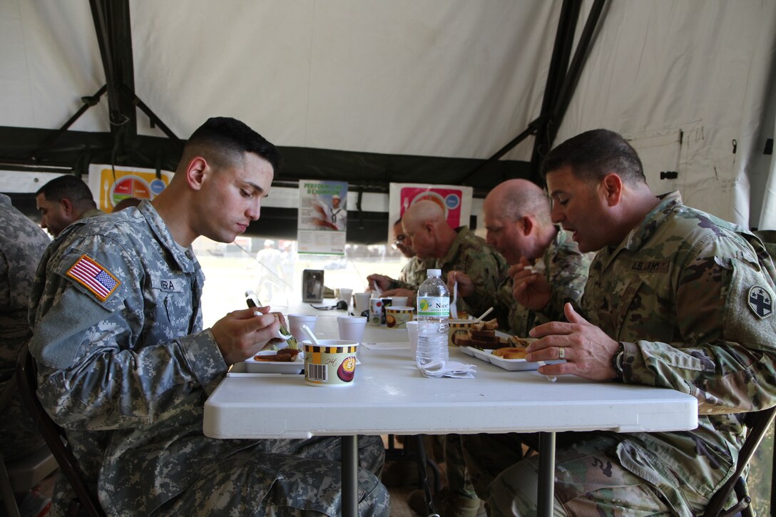 Soldiers from the 49th Multifunctional Medical Battalion join the Commanding General of the 3rd Medical Command, Maj. Gen. William S. Lee, in sampling the food prepared at the 2017 Philip A. Connelly Competition in Puerto Nuevo, Puerto Rico.