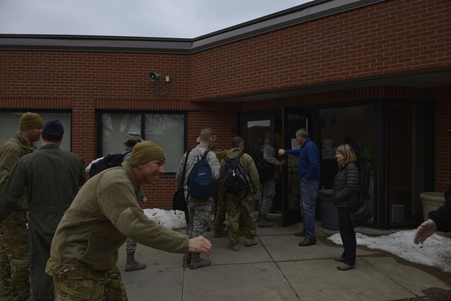 Maj. Chad Versteeg extends his hand as members of the 934th Airlift Wing welcome him home from his deployment to an undisclosed location in Southwest Asia. (U.S. Air Force photo by Capt. William-Joseph Mojica)