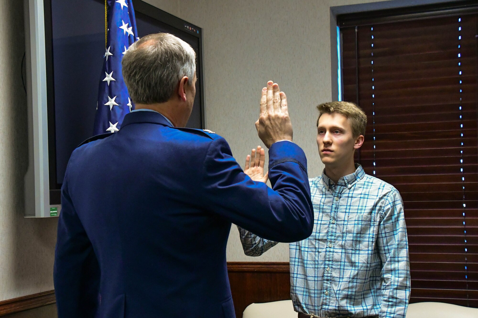 Col. Robert Burgess, commander of the 307th Operations Group, Barksdale Air Force Base, La., swears in his son, Adam Burgess, as an Air Force officer during a ceremony on Barksdale AFB, March 15, 2017. Adam will be attending college in the fall and plans to serve his commission in the Air Force as a doctor. (U.S. Air Force photo by Master Sgt. Dachelle L. Melville/Released)