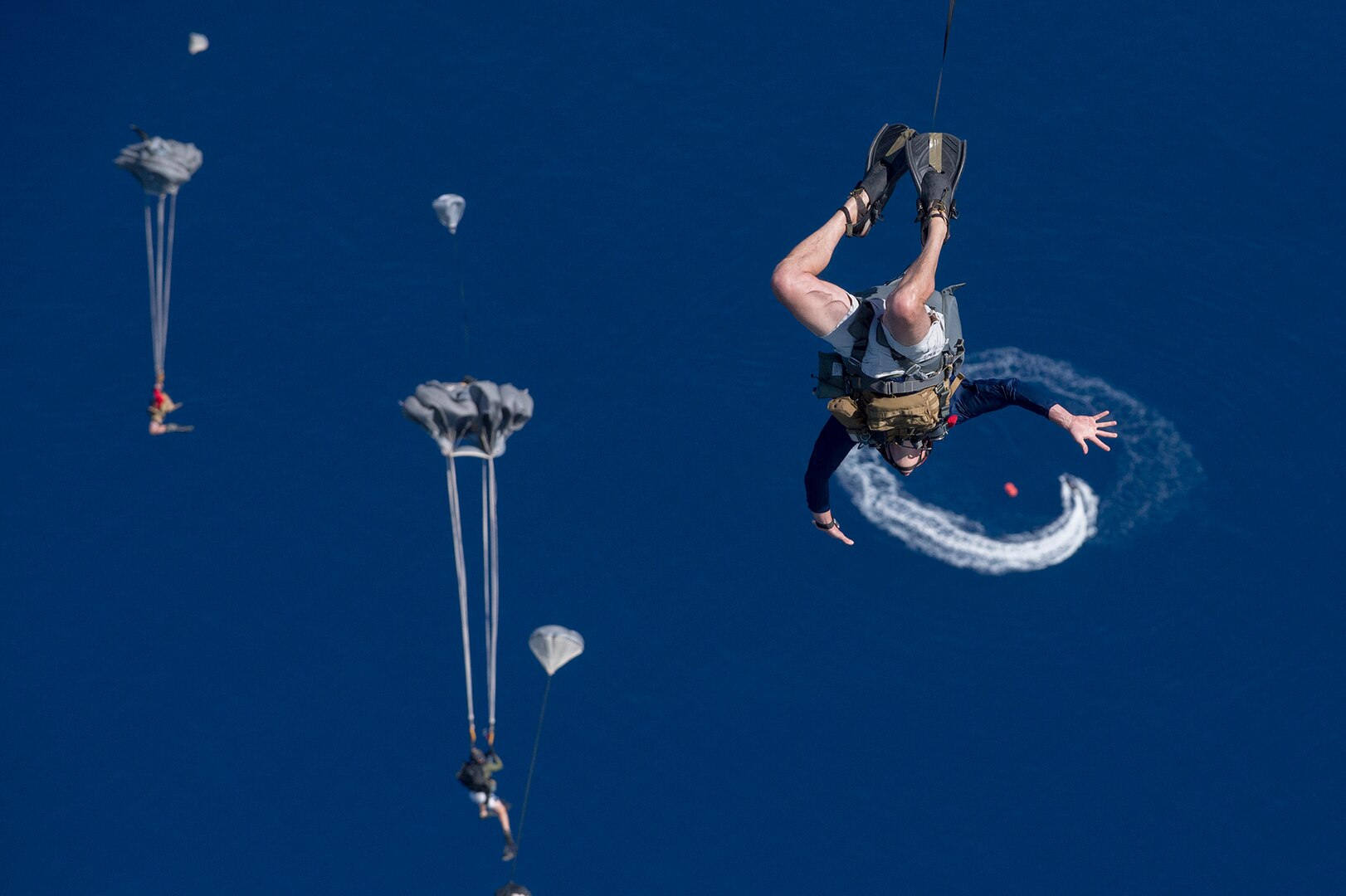 Pararescuemen and Combat Rescue Officers with the New York Air National Guard's 103rd Rescue Squadron, 106th Rescue Wing, supported by the Hawaii Air National Guard's 154th Wing, 204th Airlift Squadron, jump from a C-17 into the waters off Joint Base Pearl Harbor- Hickam on March 7, 2017, as they conduct training to test new spacecraft recovery techniques and equipment that will be used to recover the crew module of NASA's Orion spacecraft. The Airmen were in Hawai for two weeks as part of Operation Ardent Sentry.