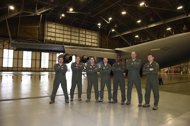 A group of seven Mobility Guardian planners stand in front of a C-17 Globemaster III in a McChord Field hangar at Joint Base Lewis-McChord, Wash., March 15, 2017. The group coordinated an airspace plan for Air Mobility Command’s Mobility Guardian exercise that will take place here at JBLM this summer. (U.S. Air Force/Staff Sgt. Naomi Shipley)