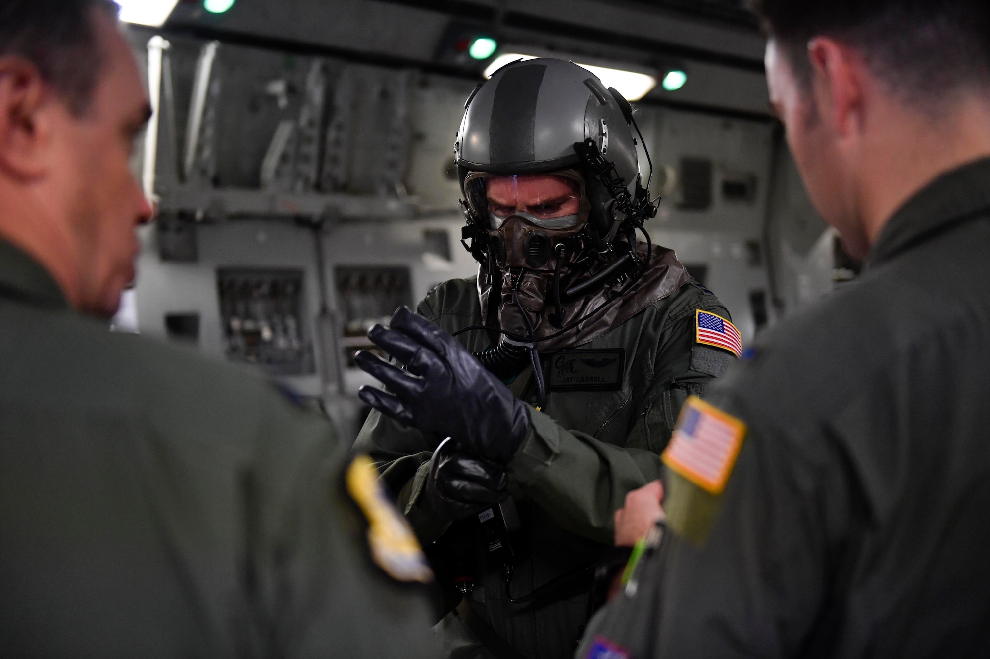 Capt. Jason Carroll, 15th Airlift Squadron airdrop instructor pilot before a flight to North Auxiliary Airfield in North, South Carolina, March 15, 2017 to execute in-flight training with aircrew eye and respiratory protection system (AERPS) equipment. The flight marked the first time in more than 10 years where aircrews wore AERPS equipment. AERPS equipment consists of a rubber mask, multiple layers of boots and gloves, fan filter system and an audio and speaker system.