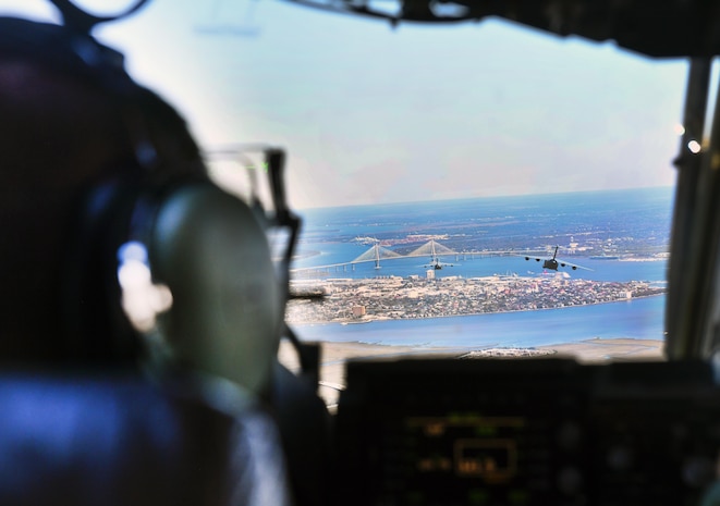Capt. Bryce Weir, 15th Airlift Squadron pilot, operates a C-17 Globemaster III during a flight to North Auxiliary Airfield in North, South Carolina, March 15, 2017 to execute in-flight training with aircrew eye and respiratory protection system (AERPS) equipment. The flight marked the first time in more than 10 years where aircrews wore AERPS equipment. AERPS equipment consists of a rubber mask, multiple layers of boots and gloves, fan filter system and an audio and speaker system.
