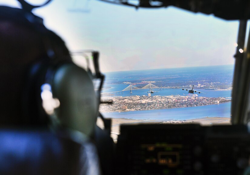 Capt. Bryce Weir, 15th Airlift Squadron pilot, operates a C-17 Globemaster III during a flight to North Auxiliary Airfield in North, South Carolina, March 15, 2017 to execute in-flight training with aircrew eye and respiratory protection system (AERPS) equipment. The flight marked the first time in more than 10 years where aircrews wore AERPS equipment. AERPS equipment consists of a rubber mask, multiple layers of boots and gloves, fan filter system and an audio and speaker system.