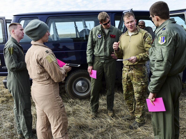 Airmen from Ellsworth Air Force Base, S.D., listen as a Survival, Evasion, Resistance and Escape instructor gives direction during exercise Combat Raider at the Powder River Training Complex, March 15, 2017. These volunteers acted as downed pilots, playing out a card describing their injuries and creating a realistic environment for the rescue team. (U.S. Air Force photo by Airman 1st Class Randahl J. Jenson)