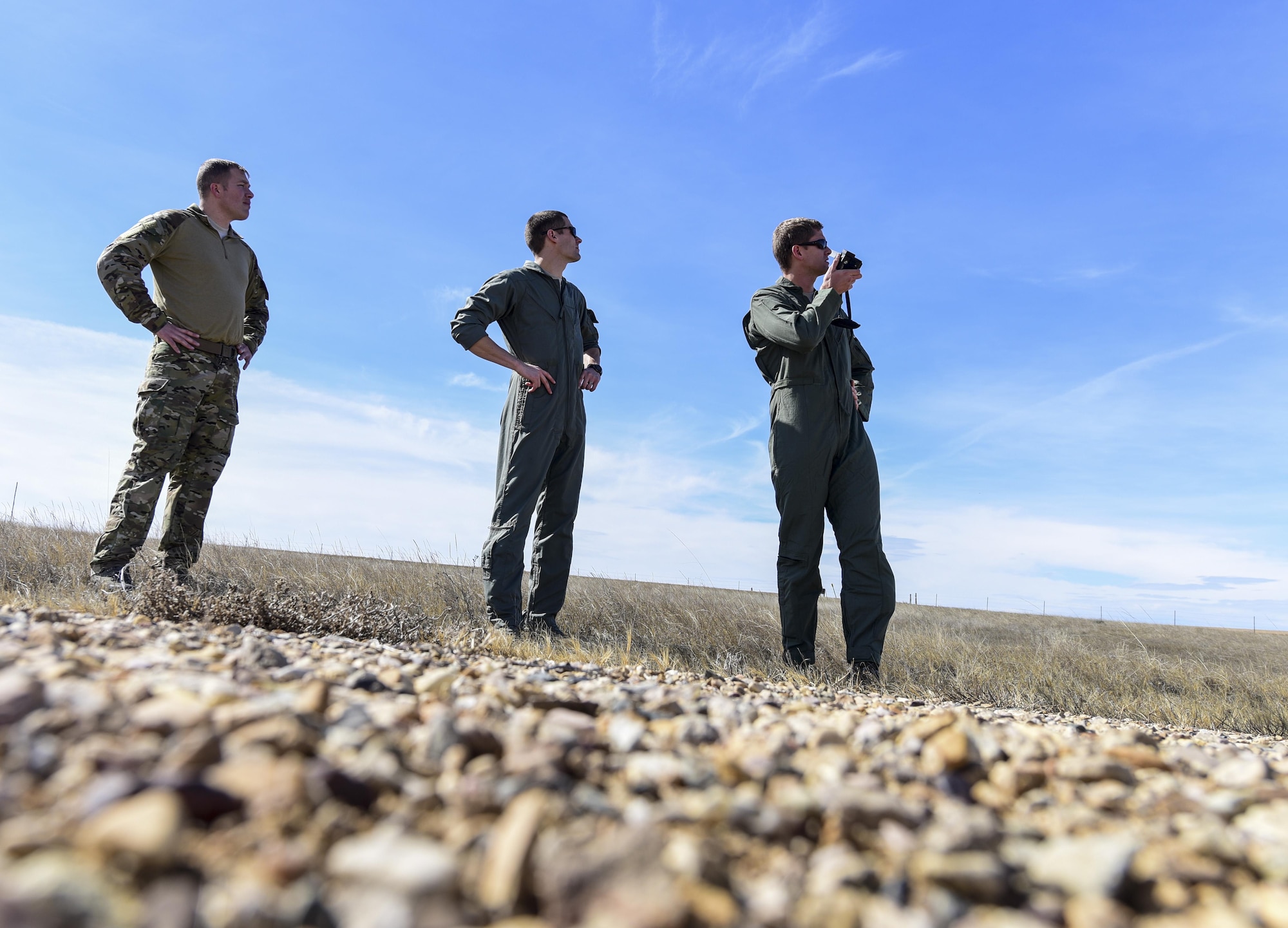 Airmen from Ellsworth Air Force Base, S.D., call in a HH-60M Black Hawk helicopter during exercise Combat Raider at the Powder River Training Complex, north of Belle Fourche, S.D., March 15, 2017. Survival, Evasion, Resistance and Escape instructors were there, teaching volunteers how to radio-in their position to rescue teams without giving it away to any potential adversary listening. (U.S. Air Force photo by Airman 1st Class Randahl J. Jenson)