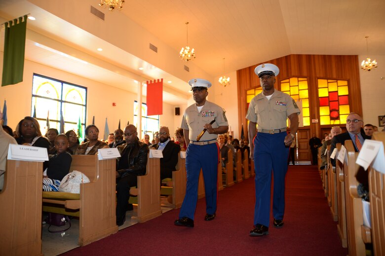 Sgt. Maj. Kenneth V. Agee, left, outgoing sergeant major, Marine Corps Logistics Base Albany, transfers senior staff noncommissioned officer authority to Sgt. Maj. Johnny L. Higdon, incoming sergeant major, during a post and relief ceremony at the Chapel of the Good Shepherd, here, March 16. 