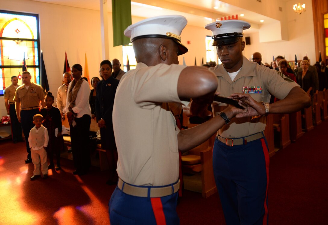 Sgt. Maj. Johnny L. Higdon, sergeant major, Marine Corps Logistics Base Albany, receives a noncommissioned officer's sword from Col. James C. Carroll III, commanding officer, MCLB Albany, completing the transfer of senior staff noncommissioned officer authority during a post and relief ceremony at the Chapel of the Good Shepherd, here, March 16. 