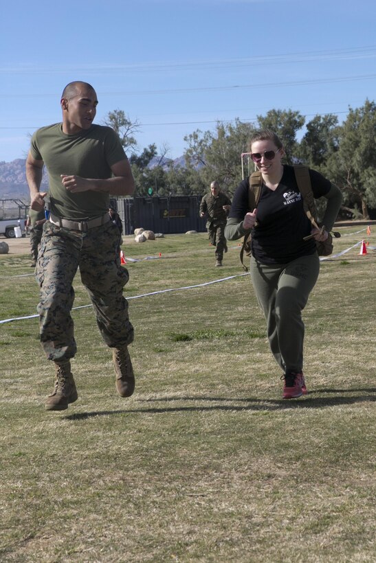The wife of a Marine with 3rd Battalion, 4th Marines, 7th Marine Regiment, runs with a weighted pack during a modified Combat Fitness test at Del Valle Field during the battalion’s Jane Wayne Day aboard Marine Corps Air Ground Combat Center Twentynine Palms Calif. March 8, 2017. (U.S. Marine Corps Photo by Cpl. Julio McGraw)