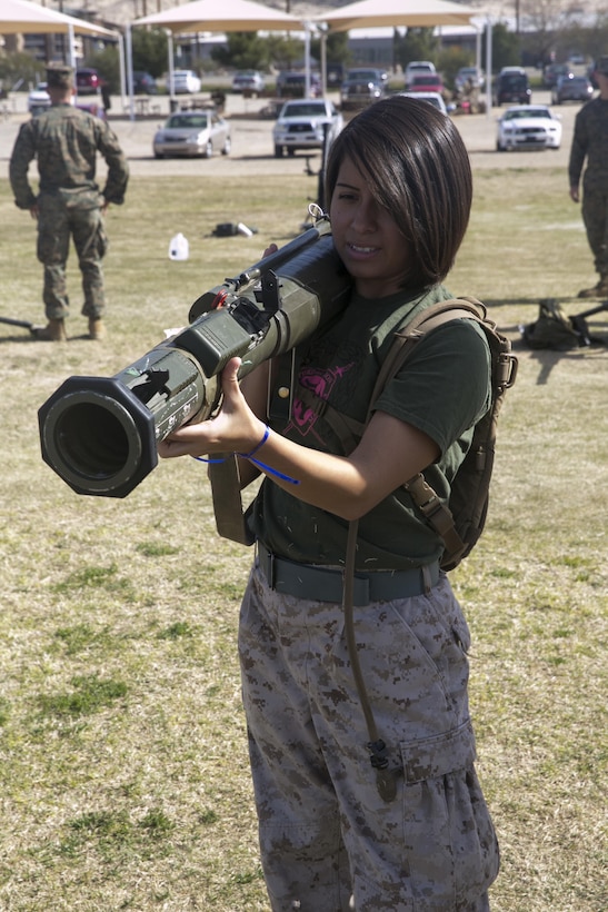 The wife of a Marine with 3rd Battalion, 4th Marines, 7th Marine Regiment, holds an M136 AT4 trainer at Del Valle Field during the battalion’s Jane Wayne Day aboard Marine Corps Air Ground Combat Center, Twentynine Palms, Calif., March 8, 2017. (U.S. Marine Corps photo by Cpl. Julio McGraw)