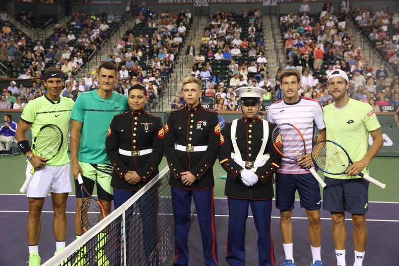 Cpl. Julian Guerrero, company clerk, Headquarters Battalion, and Cpl. Logan Winterstein  and Sgt. Rafael Fernandez, special intelligence system administrators, G-6 Communications and Information Systems, Headquarters Battalion are honored during the 15th Banque Nationale de Paris Paribas Open’s “Salute to Heroes,” in Indian Wells, Calif., March 10, 2017. This event began in 2002 after Sept. 11, and is meant to celebrate, recognize and honor all service men and women as well as first responders. (U.S. Marine Corps photo by Cpl. Julio McGraw)