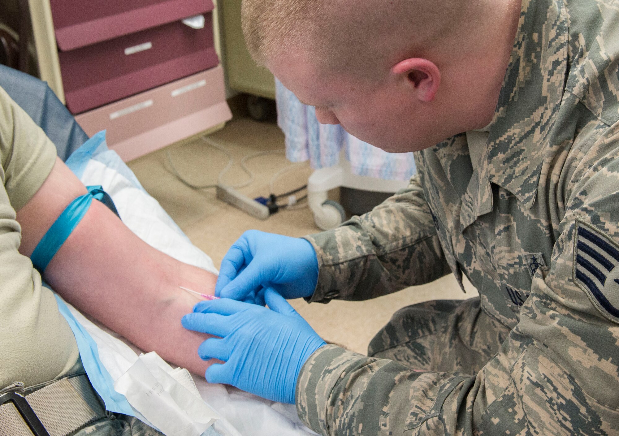 Staff Sgt. Lucas Robbins, 366th Medical Group paramedic, inserts an IV into an airman's arm March 16, 2017, at Mountain Home Air Force Base, Idaho. Patient safety week was Mar 12-18, and has been a national campaign since 2002. (U.S. Air Force photo by Airman Jeremy D. Wolff/Released)