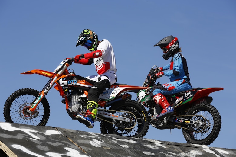 Two of the three freestyle racers sit atop the landing ramp after completing their stunts during the Motocross Jam Fest, at 13th and Dunham aboard Marine Corps Air Ground Combat Center, Twentynine Palms, Calif., March 11, 2017. Marine Corps Community Services hosts the Motocross Jam Fest annually to provide Combat Center patrons with the opportunity to enjoy time out with their family and friends. (U.S. Marine Corps photo by Lance Cpl. Natalia Cuevas)