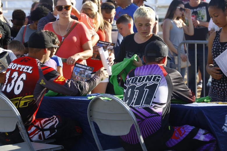The racers sign autographs after the Motocross Jam Fest, at 13th and Dunham aboard Marine Corps Air Ground Combat Center, Twentynine Palms, Calif., March 11, 2017. Marine Corps Community Services hosts the Motocross Jam Fest annually to provide Combat Center patrons with the opportunity to enjoy time out with their family and friends. (U.S. Marine Corps photo by Lance Cpl. Natalia Cuevas)
