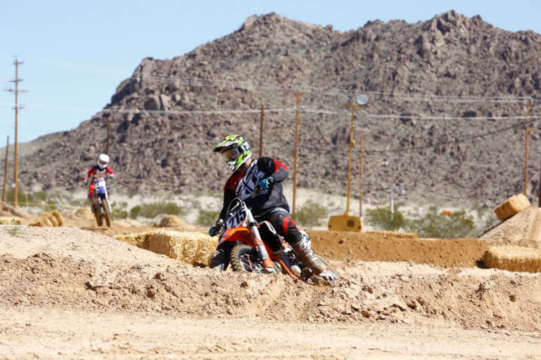 Riders compete to get first place during the Motocross Jam Fest, at 13th and Dunham aboard Marine Corps Air Ground Combat Center, Twentynine Palms, Calif., March 11, 2017. Marine Corps Community Services hosts the Motocross Jam Fest annually to provide Combat Center patrons with the opportunity to enjoy time out with their family and friends. (U.S. Marine Corps photo by Lance Cpl. Natalia Cuevas)