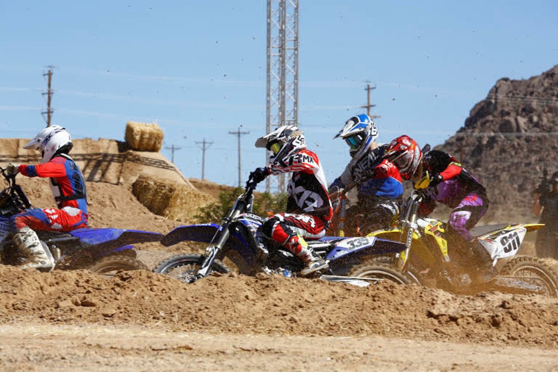 Riders race each other during the Motocross Jam Fest, at 13th and Dunham aboard Marine Corps Air Ground Combat Center, Twentynine Palms, Calif., March 11, 2017. Marine Corps Community Services hosts the Motocross Jam Fest annually to provide Combat Center patrons with the opportunity to enjoy time out with their family and friends. (U.S. Marine Corps photo by Lance Cpl. Natalia Cuevas)