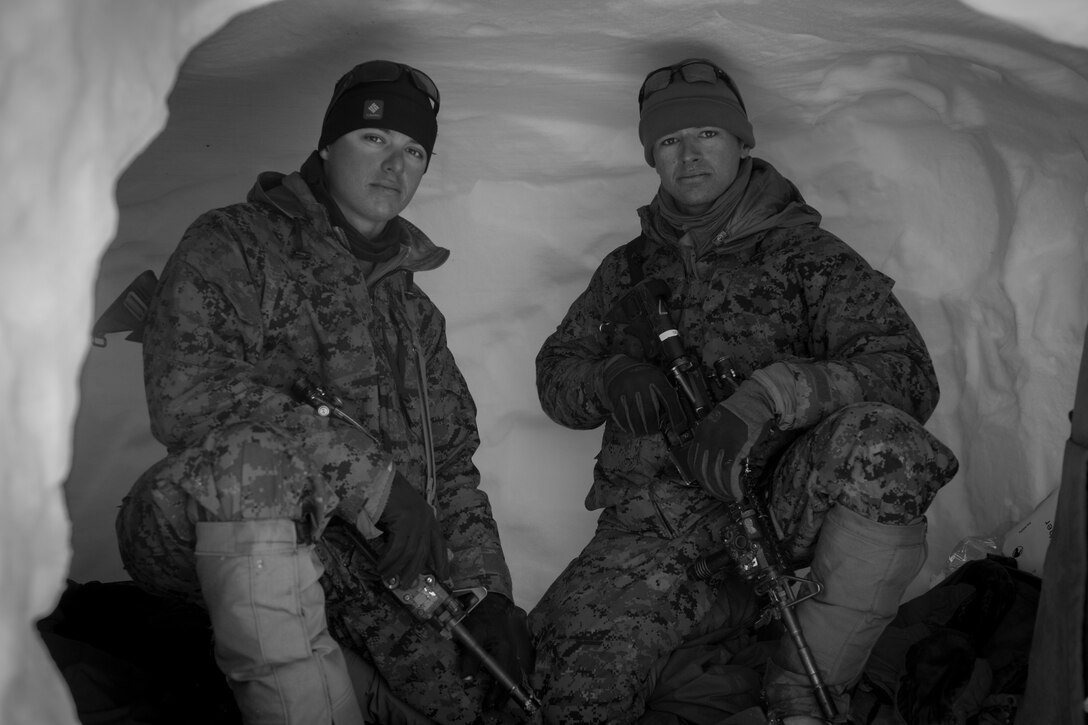Cpl. Bradley Roberts and Cpl. Charlie Elia, combat engineers, 1st Combat Engineer Battalion, take a break in their snow cave during Mountain Training Exercise 2-17 near Levitt Training Area aboard Marine Corps Mountain Warfare Training Center, Bridgeport, Calif., March 15, 2017. MTX is a service-level training exercise focused on the technical aspects of mountain and cold weather operations. (Marine Corps photo by Cpl. Connor Hancock)