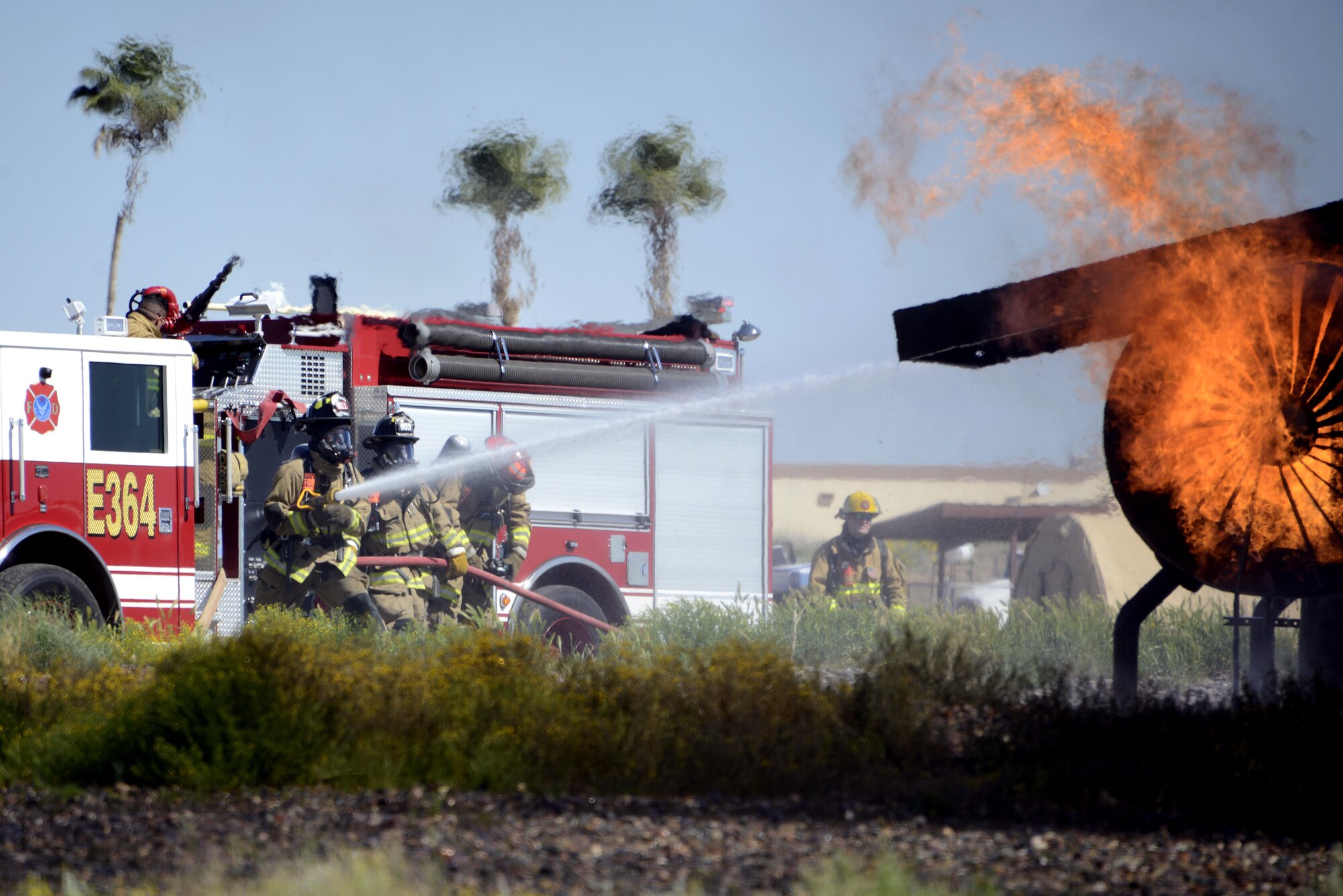 56th Civil Engineer Squadron firefighters and the Scottsdale Fire Department work together to put out a fire during a training exercise Mar. 16, 2017 at Luke Air Force Base, Ariz. The firefighters were training to respond to an aircraft fire. (U.S. Air Force photo by Senior Airman Devante Williams)  