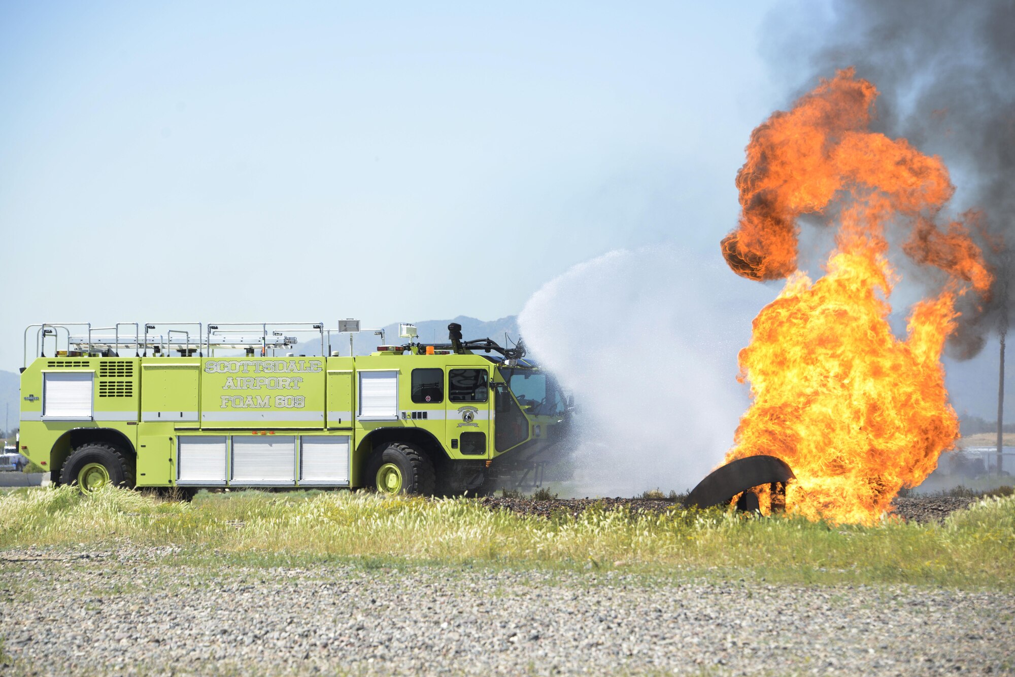 The Scottsdale Fire Department use a rapid intervention vehicle to respond to a simulated aircraft fire during training with Luke firefighters Mar. 16, 2017 at Luke Air Force Base, Ariz. The firefighters were training on stabilizing an aircraft fire using RIVs. (U.S. Air Force photo by Senior Airman Devante Williams)  