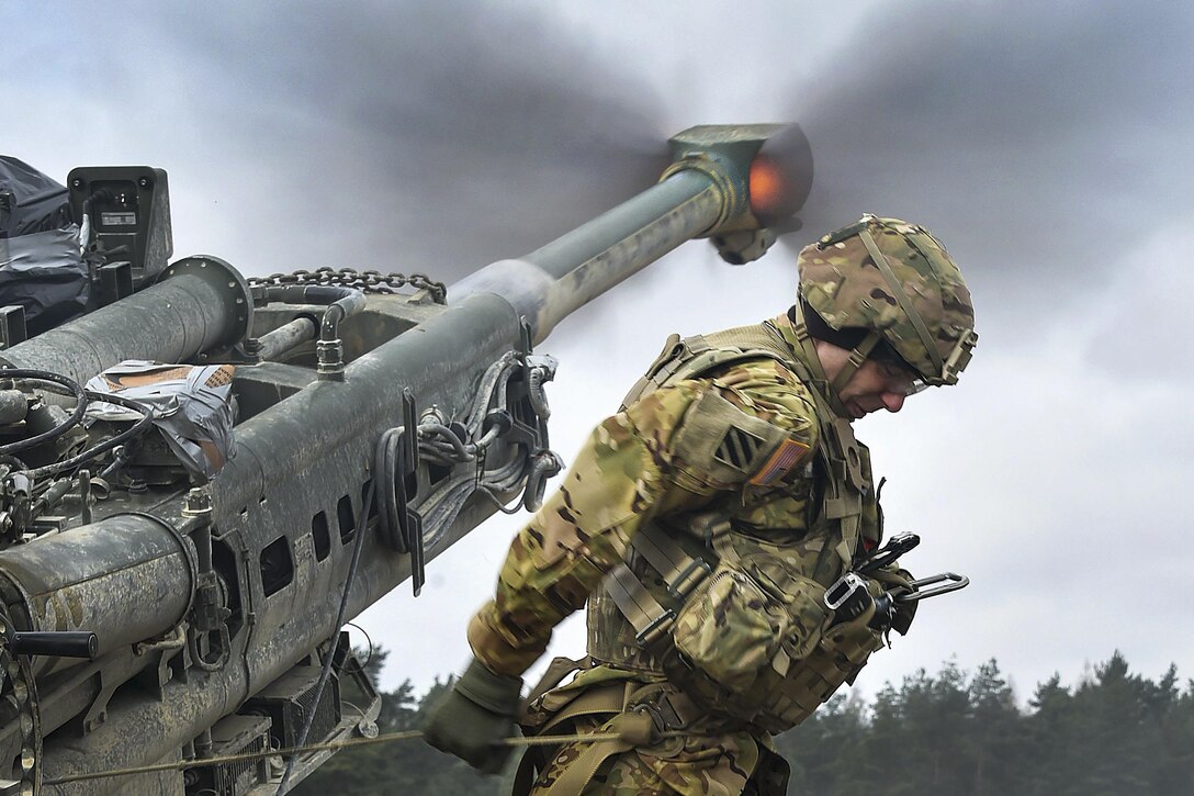 Army Spc. Vincent Ventarola pulls the lanyard on a M777 howitzer during a live-fire exercise as part of Dynamic Front II at the 7th Army Training Command's Grafenwoehr Training Area, Germany, March 9, 2017. Ventarola is assigned to the Field Artillery Squadron, 2nd Cavalry Regiment. Army photo by Gertrud Zach