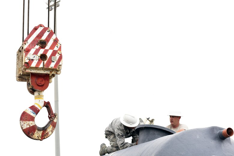 U.S. Air Force Airmen with the 379th Expeditionary Civil Engineer Squadron “Dirt Boyz” prepare to lift a sewage tank at Al Udeid Air Base, Qatar, March 4, 2017. The Dirt Boyz play a major role in the 379th ECES cadillac trailer plan to repair, recommission, renovate and replace old cadillac latrines at Al Udeid AB. (U.S. Air Force photo by Senior Airman Cynthia A. Innocenti)