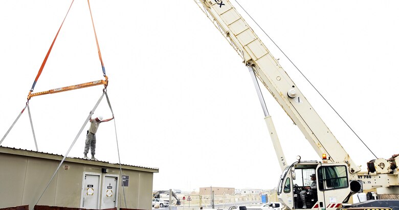 U.S. Air Force Airmen with the 379th Expeditionary Civil Engineer Squadron “Dirt Boyz” prepare to lift a cadillac latrine at Al Udeid Air Base, Qatar, March 4, 2017. The Dirt Boyz play a major role in the 379th ECES cadillac trailer plan to repair, recommission, renovate and replace old cadillac latrines at Al Udeid AB. (U.S. Air Force photo by Senior Airman Cynthia A. Innocenti)