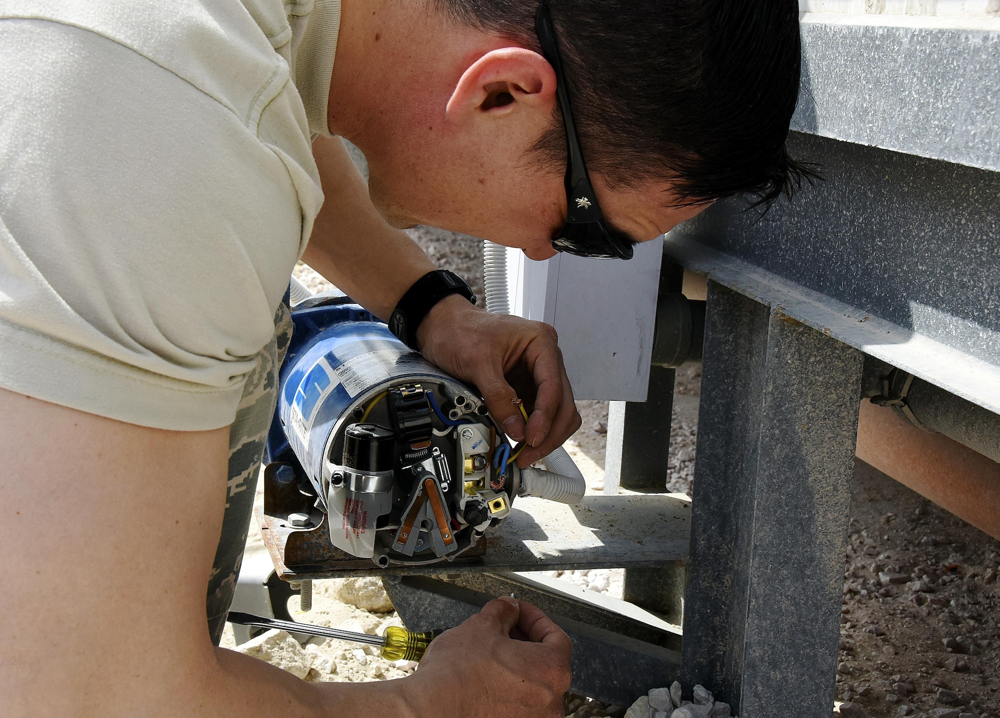 U.S. Air Force Master Sgt. Alan Vong, section chief with the 379th Expeditionary Civil Engineer Squadron Water and Fuels Section, connects a wire at Al Udeid Air Base, Qatar, March 17, 2017. Airmen with the water and fuels section have played a major role in the 379th ECES cadillac trailer plan, prioritizing the improvement of facilities on Al Udeid AB. (U.S. Air Force photo by Senior Airman Cynthia A. Innocenti)