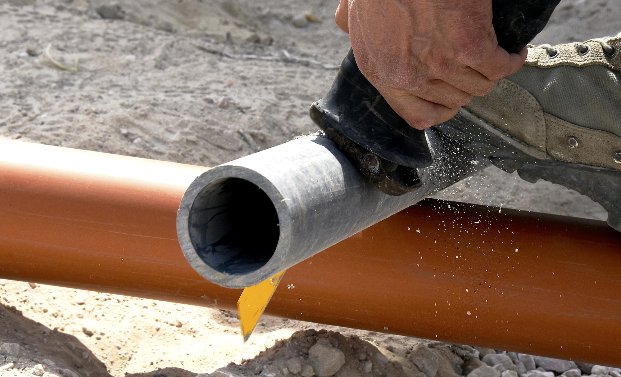 An Airmen with the 379th Expeditionary Civil Engineer Squadron Water and Fuels Section cuts a pipe at Al Udeid Air Base, Qatar, March 17, 2017. Airmen with the 379th ECES Water and Fuels Section have played a major role in the 379th ECES cadillac trailer plan, one part of the continued improvement of facilities on Al Udeid AB. (U.S. Air Force photo by Senior Airman Cynthia A. Innocenti)