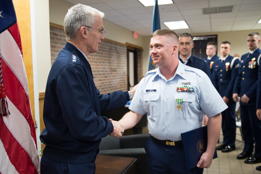 Air Force Gen. Paul J. Selva, vice chairman of the Joint Chiefs of Staff, congratulates U.S. Coast Guard Gunner's Mate Second Class Nicholas Ligon on his receipt of the Coast Guard Achievement Medal while visiting the men and women of the Coast Guard’s Telecommunication and Information Systems Command in Alexandria, Va., March 17, 2017. DoD photo by Army Sgt. James K. McCann