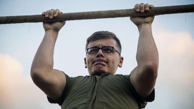 Lance Cpl. Austin Walls, a technical controller with Headquarters Battalion, conducts pull-ups during a Physical Fitness Test at Marine Corps Base Hawaii, March 14, 2017. The PFT is an evaluation conducted throughout the Marine Corps annually to assess the level of fitness. For more information on the PFT updates, utilize Marine Corps Bulletin 6100.