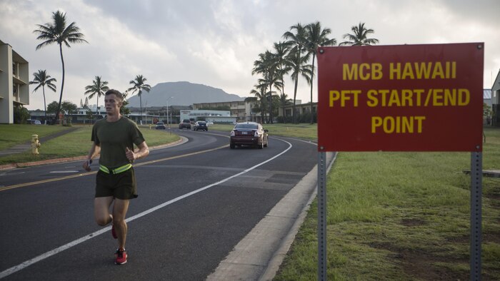 Sgt. Ty Stulce, a platoon sergeant with Headquarters Battalion, crosses the finish line from a 3-mile run during a Physical Fitness Test at Marine Corps Base Hawaii, March 14, 2017. The PFT is an evaluation conducted throughout the Marine Corps annually to assess the level of physical fitness. For more information on the PFT updates, utilize Marine Corps Bulletin 6100.