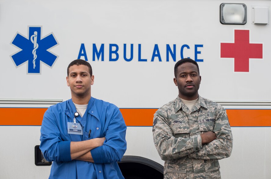 U.S. Air Force Senior Airman Andrew Rankin, 35th Surgical Squadron surgery technician, left, and Staff Sgt. Robert Smith III, 35th Medical Group medical deployments NCO in charge, right, stand in front of an ambulance at Misawa Air Force Base, Japan, March 1, 2017. Rankin and Smith III each won an Air Force Medical Service 2016 award in their respective career field. Rankin won the U.S. Air Force Surgical Service Airman of the Year, Smith III won the U.S. Air Force Enlisted Health Services Management NCO of the Year and Tech. Sgt. Elyot Selman, 20th Mental Health NCO in charge, not pictured, won the U.S. Air Force Mental Health NCO of the Year. (U.S. Air Force photo by Senior Airman Brittany A. Chase)   