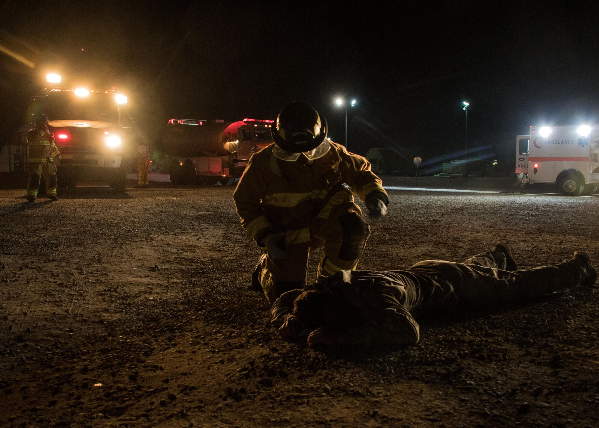Senior Airman Derek Holmes, a 386th Expeditionary Civil Engineer Squadron firefighter, conducts an initial patient assessment during a drill at an undisclosed location in Southwest Asia March 10, 2017. He simulated checking for major injuries and determining whether the patient was conscious. (U.S. Air Force photo/Senior Airman Andrew Park)