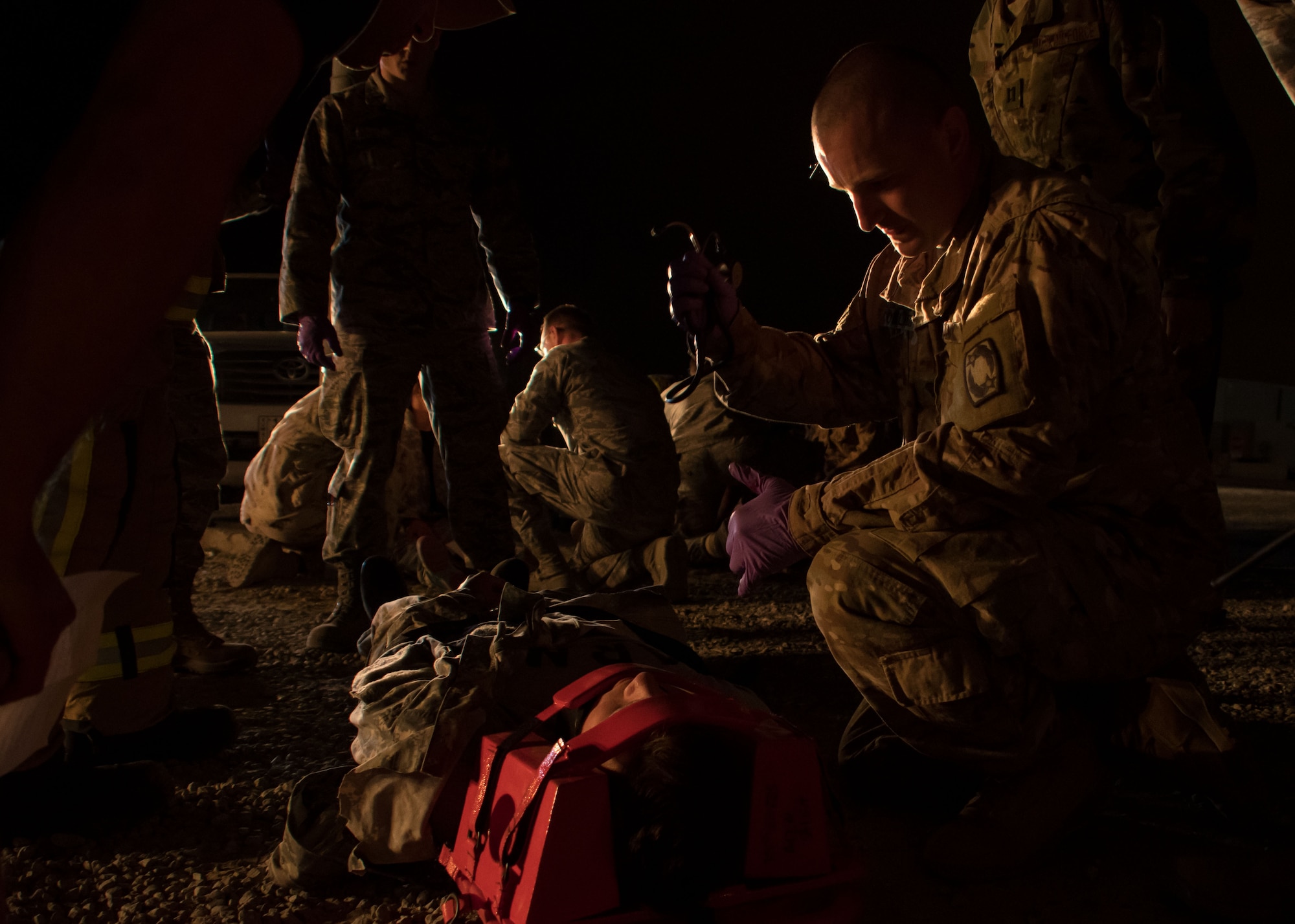 A U.S. Army medic, right, inspects a patient during a drill at an undisclosed location in Southwest Asia March 10, 2017. A group of firefighters and medics worked together to stabilize the patient and secured the patient’s head in preparation for medical transport. (U.S. Air Force photo/Senior Airman Andrew Park)