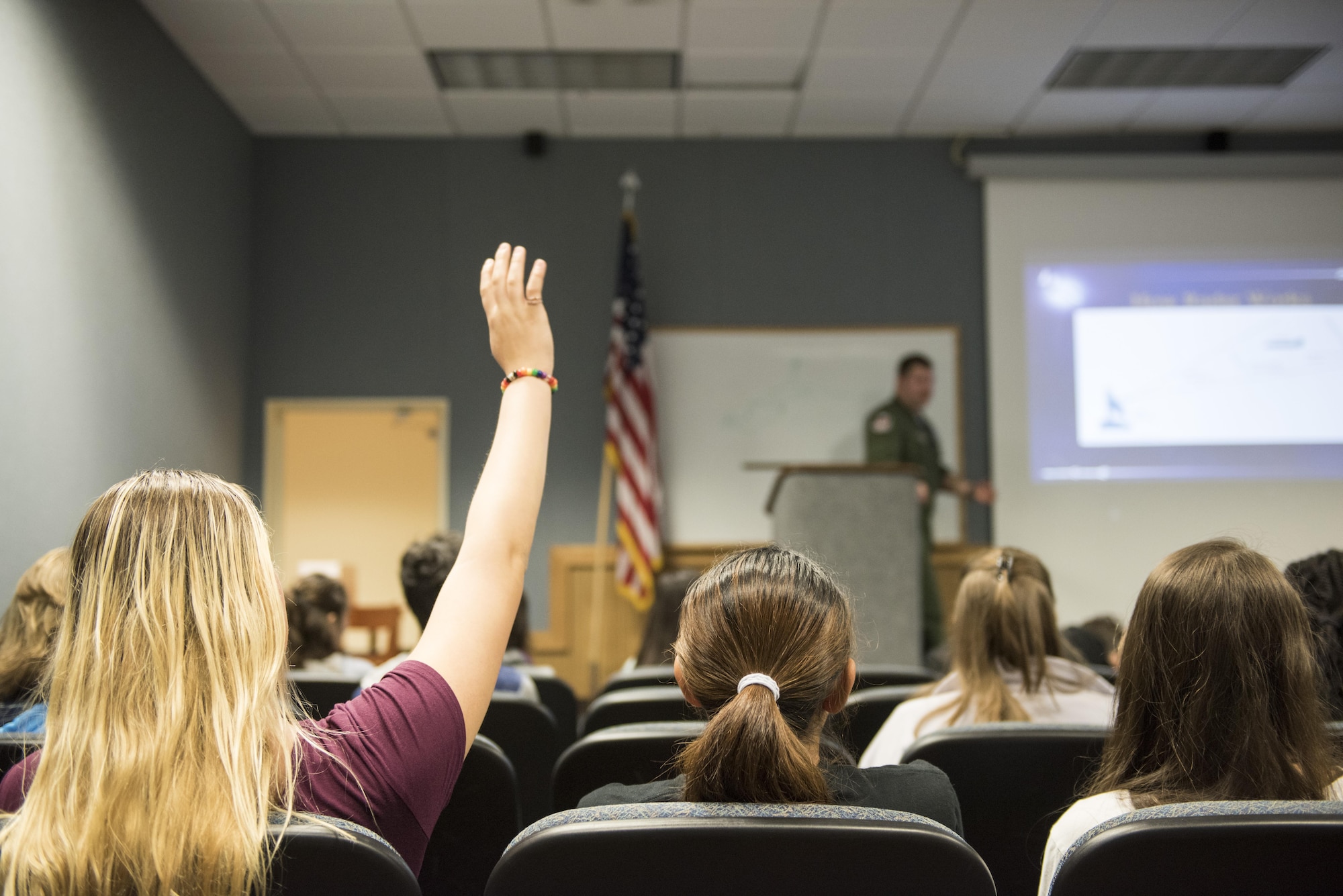 A Kadena Middle School student raises her hand to ask a question during a Science, Technology, Engineering and Math tour at the 18th Operations Support Squadron March 3, 2017, at Kadena Air Base, Japan.  The students toured the 18th OSS to see examples of how STEM is used at Kadena AB. (U.S. Air Force photo by Senior Airman Omari Bernard)