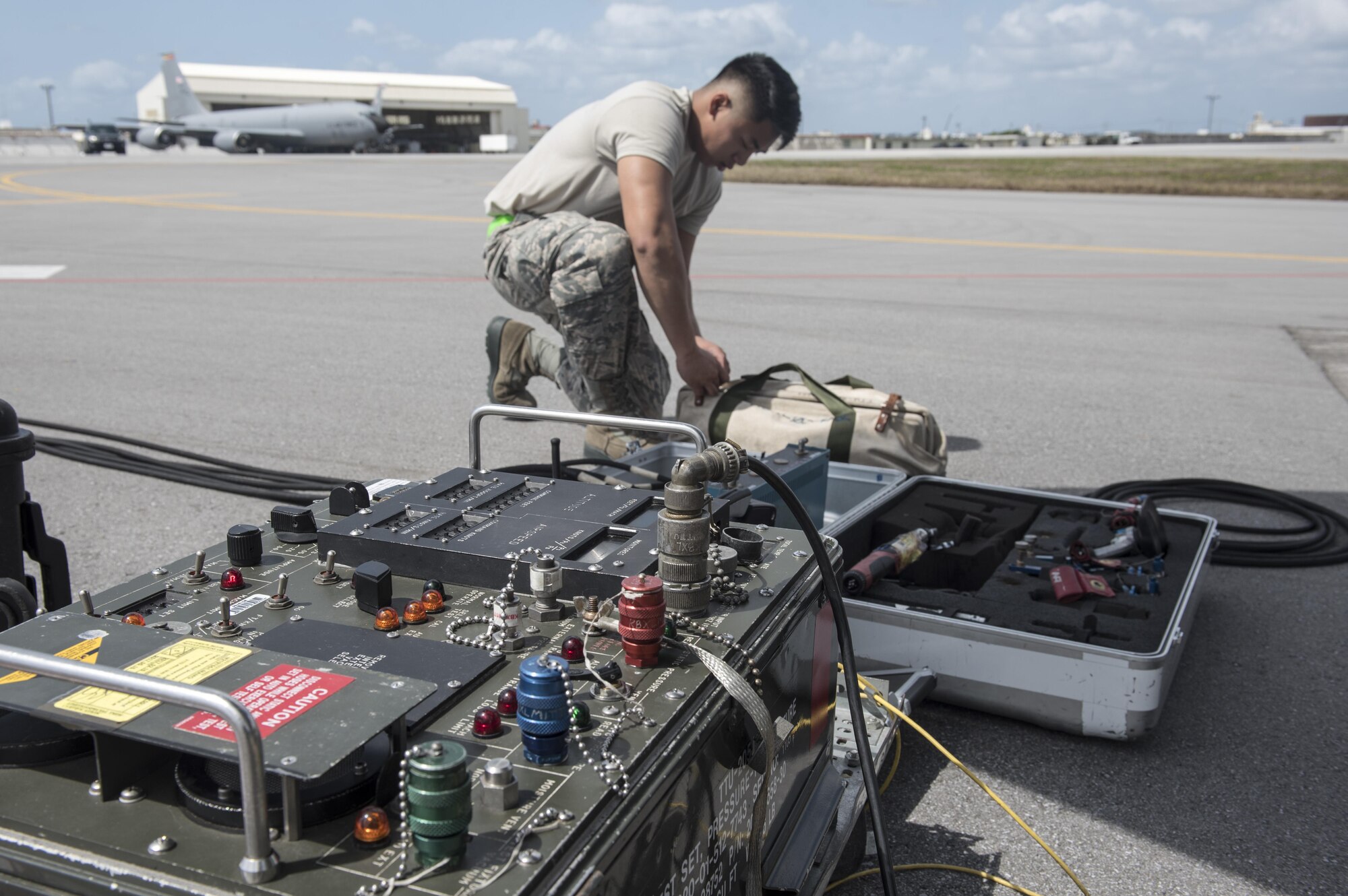 U.S. Air Force Airman 1st Class Ryan Celestino, 909th Aircraft Maintenance Unit instrument and flight control systems journeyman, sets up equipment to perform maintainance on a KC-135R March 15, 2017, at Kadena Air Base, Japan. Maintenance Airmen use assorted sets of tools to ensure the mission capability of their aircraft. (U.S. Air Force photo by Senior Airman Omari Bernard)