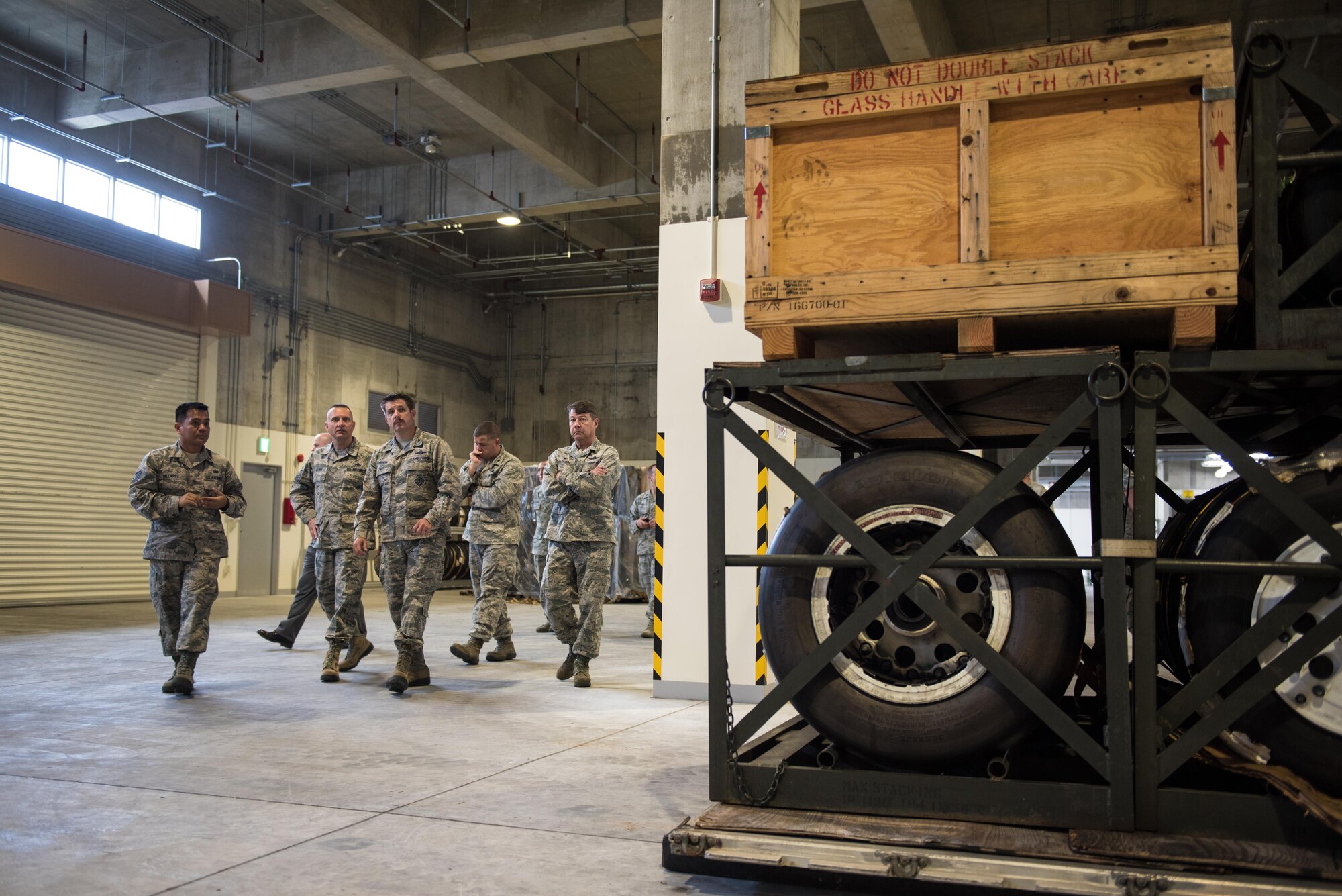 Commanders from the 18th Wing tour one of two new 18th Logistics Readiness Squadron facilities March 13, 2017, at Kadena Air Base, Japan. The facilities can contain anything from fighter jet parts to cooking supplies. The new facilities hold more than a billion dollars of U.S. Air Force assets and was funded in part by the government of Japan. (U.S. Air Force photo by Senior Airman Omari Bernard)