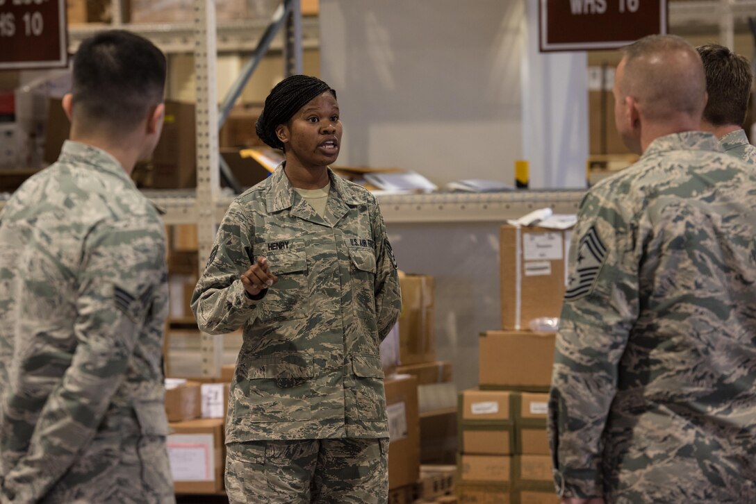 U.S. Air Force Staff Sgt. Latoya Henry, 18th Logistics Readiness Squadron integrated receiving supervisor, talks about the mission capabilities of their new LRS facility, March 13, 2017, at Kadena Air Base, Japan. The facilities are equipped with a conveyor belt system, floor mounted scales, and adjustable loading docks. (U.S. Air Force photo by Senior Airman Omari Bernard)