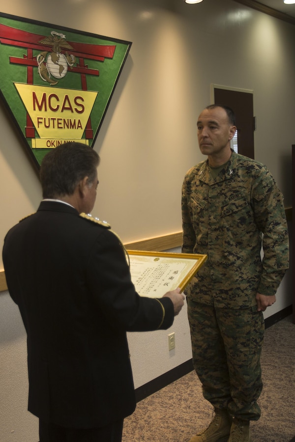 Ginowan Police Chief Motoki Haneji presents a letter of appreciation presented to Col. Peter N. Lee Feb. 28 on Marine Corps Air Station Futenma, Okinawa, Japan. As commanding officer of MCAS Futenma, Lee oversaw various programs to help Marines embody the motto ‘protect what you’ve earned.’ “Please continue your contribution to Okinawa, the United States, Japan and the world,” said Haneji.