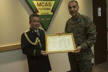 Ginowan Police Chief Motoki Haneji, left, awards Col. Peter N. Lee with a letter of authorization Feb. 28 on Marine Corps Air Station Futenma, Okinawa, Japan. Lee was recognized by Haneji for the significant mutual support and cooperation between MCAS Futenma and the Ginowan City Police Department during the chief’s command tenure. Haneji is retiring from his duties as chief of the Ginowan Police Department. "Since the chief has arrived at Ginowan, we've had a great relationship with him, and because of him we've really enhanced the partnership between the station and the city,” said Lee, the commanding officer of MCAS Futenma. "Because of him we will continue to strive to be the best partners we can be."