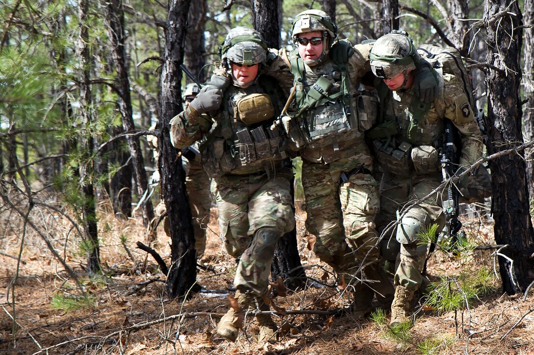 Soldiers move a mock casualty after receiving enemy gunfire during a multi-component airfield seizure training exercise, part of Warrior Exercise 78-17-01, at Joint Base McGuire-Dix-Lakehurst, N.J., March 13, 2017. Army Reserve photo by Master Sgt. Mark Bell