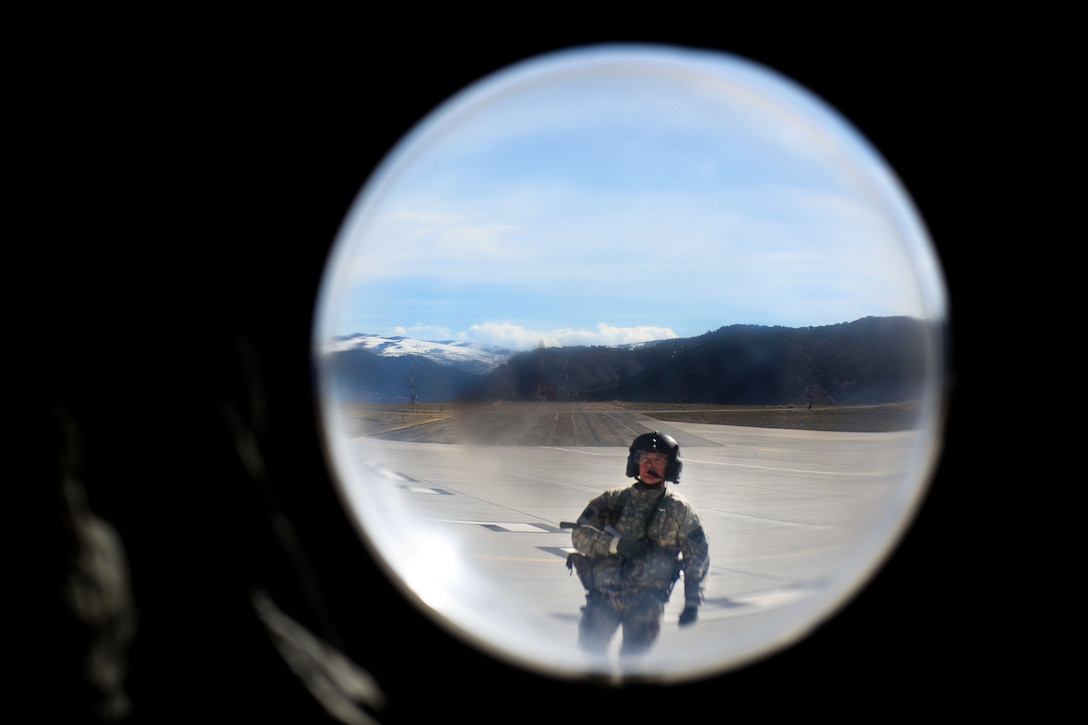 A South Carolina Army National Guard crew chief performs pre-flight checks on a CH-47F Chinook helicopter before conducting high-altitude flight operations near Vail, Colo., March 10, 2017. Army National Guard photo by Staff Sgt. Roberto Di Giovine