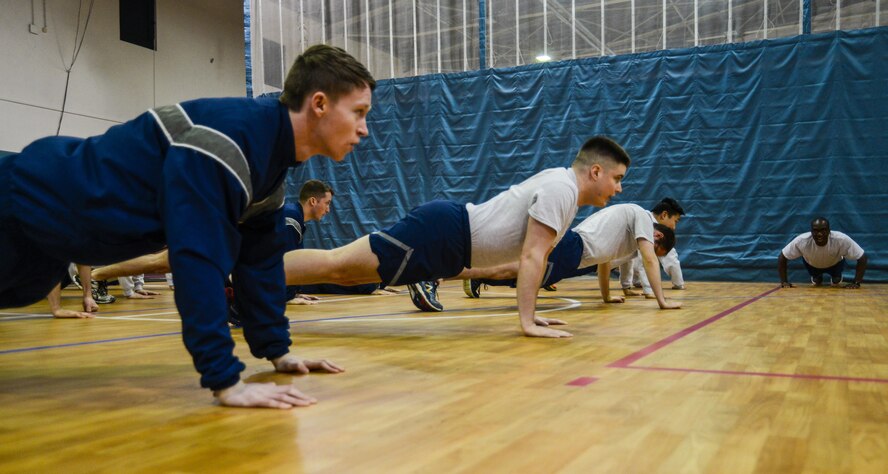 Airmen assigned to the 1st Air and Space Communications Operations Squadron perform pushups during a physical training session on Ramstein Air Base, Germany, March 14, 2017. The 1 ACOS has challenged themselves to complete 435,000 pushups by June 2018. They chose 435,000 as a way to pay homage to their wing, the 435th Air Ground Operations Wing. (U.S. Air Force photo/Staff Sgt. Timothy Moore)