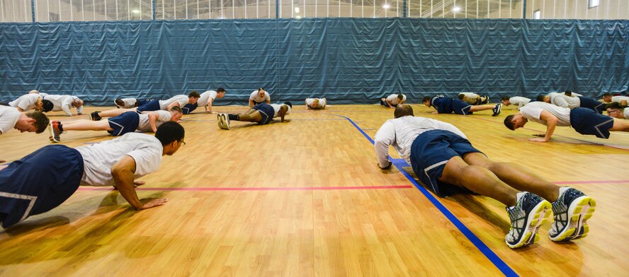 Airmen assigned to the 1st Air and Space Communications Operations Squadron perform pushups during a physical training session on Ramstein Air Base, Germany, March 14, 2017. The 1 ACOS has challenged themselves to complete 435,000 pushups by June 2018. They chose 435,000 as a way to pay homage to their wing, the 435th Air Ground Operations Wing. (U.S. Air Force photo/Staff Sgt. Timothy Moore)