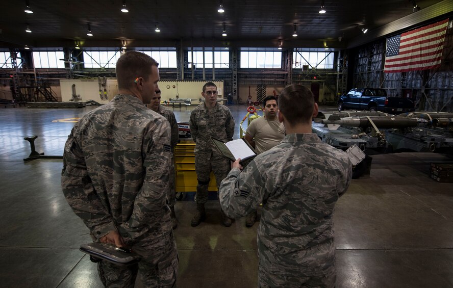 U.S. Air Force Senior Airman Jacob D. Jennings, right, a 35th Maintenance Group weapons evaluator, gives feedback to Crew 15 at Misawa Air Base, Japan, Feb. 28, 2017.  Weapons evaluators are key to ensuring crews preform every step safely, correctly and in a timely manner. Misawa is committed to enhancing stability in the Indo-Asia-Pacific region by promoting security, cooperation, deterring aggression, with continued partnership, presence and military readiness. (U.S. Air Force photo by Tech. Sgt. Araceli Alarcon)